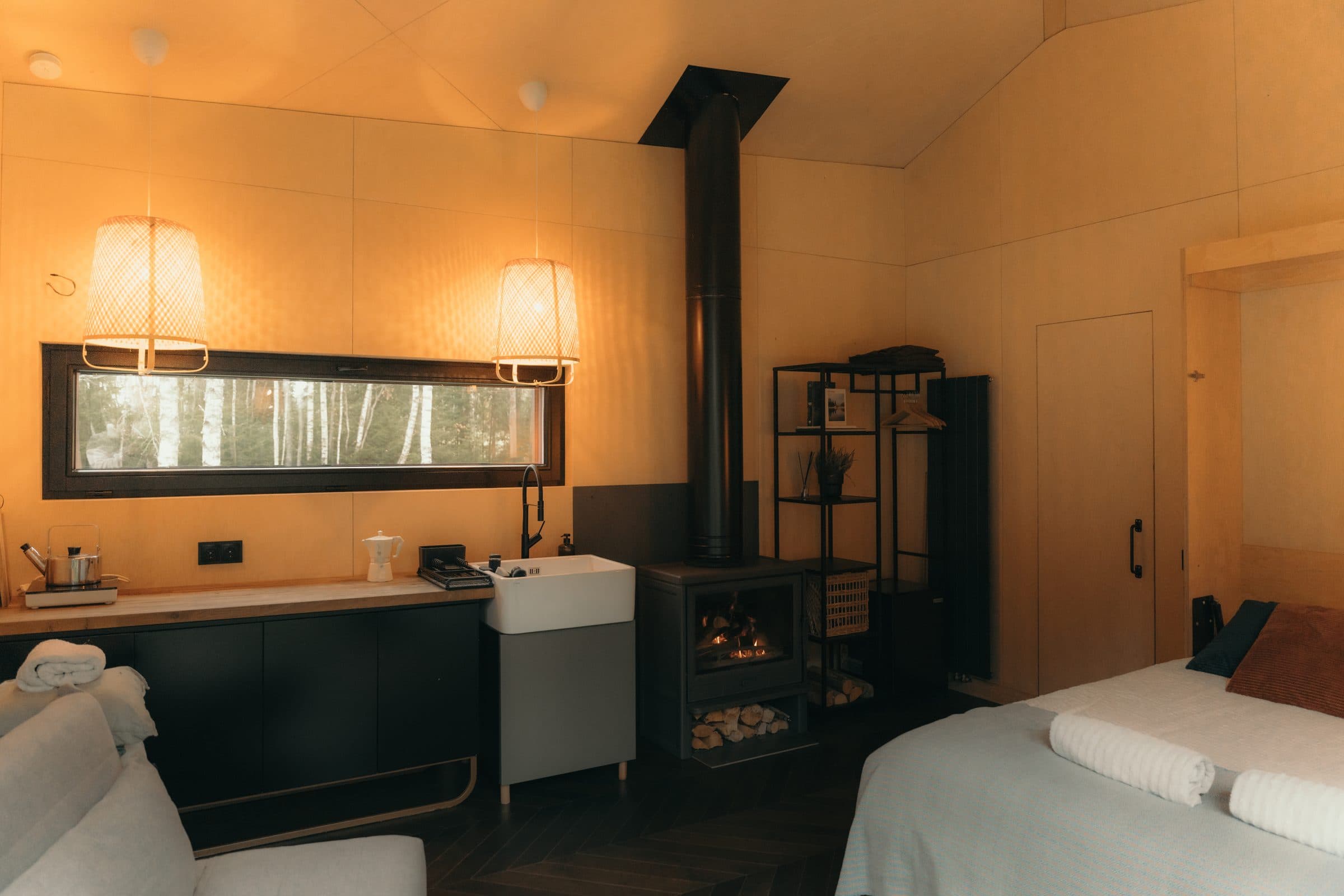 Interior wide — fireplace, bed, herringbone oak, birch veneer